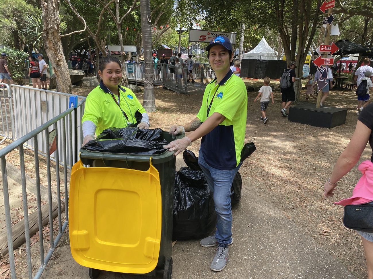 Wilclean crew in hi-vis managing waste bins at an event